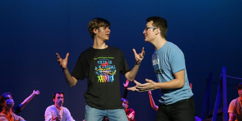 Two boys acting on stage