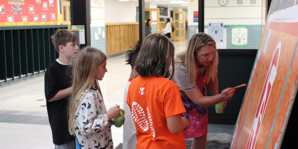 Silver Lake students and teacher painting mural