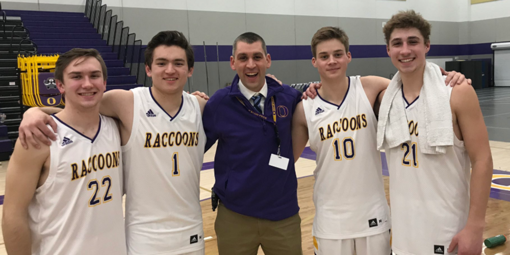 Principal Jason Curtis with boys basketball players