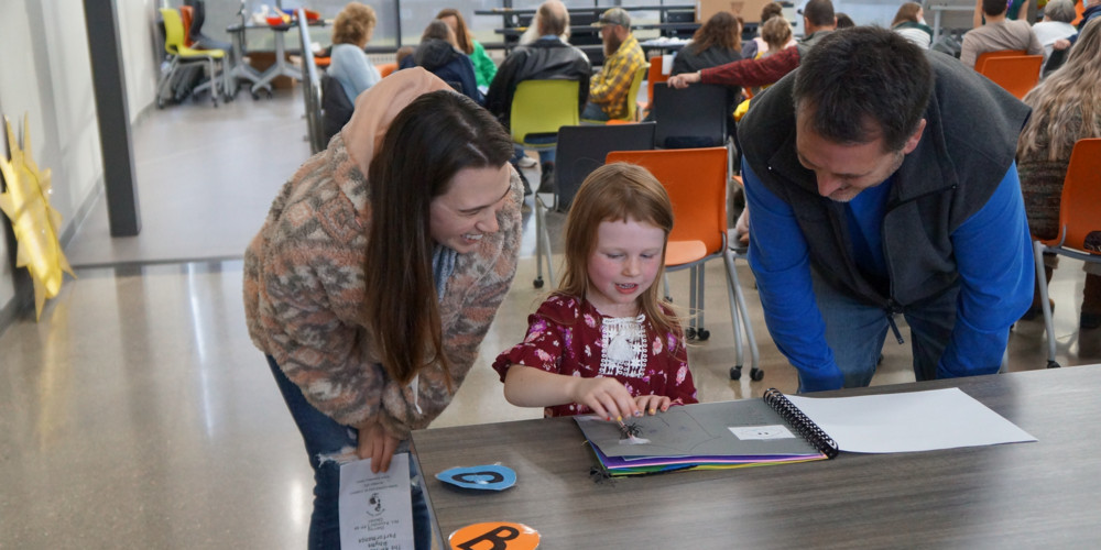 Smiling parents looking at child's artwork