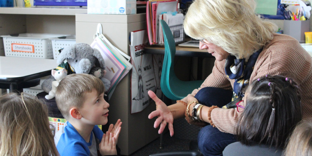 Teacher interacting with young boy