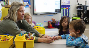 Teacher and students working on a worksheet