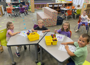 Group of students coloring in a classroom