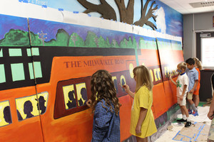 OASD elementary students painting train mural